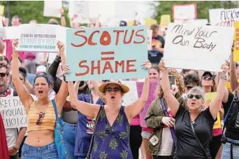  ?? AJ Mast/Associated Press ?? Abortion-rights activists rally Saturday at the Indiana Statehouse in Indianapol­is following the Supreme Court’s decision. Clinics in eight states have already stopped performing abortions.