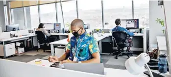  ?? KIM RAFF/THE NEW YORK TIMES ?? Employees with Vivint work at their office Feb. 16 in Lehi, Utah. The home security company is allowing 40% of its 4,000 Utah employees to return to the office voluntaril­y.