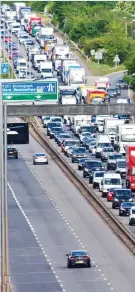  ??  ?? On the road again: Queues of traffic on the A40 near Uxbridge in London yesterday Packed: Passengers on a bus in Manchester the day after Boris Johnson signalled a relaxation of lockdown
