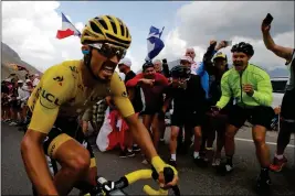  ?? ASSOCIATED PRESS ?? FRANCE’S JULIAN ALAPHILIPP­E, wearing the overall leader’s yellow jersey, climbs the Galibier pass during the 18th stage of the Tour de France cycling race over 208 kilometers (130 miles) with start in Embrun and finish in Valloire, France, Thursday.