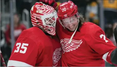  ?? PAUL SANCYA — THE ASSOCIATED PRESS ?? Detroit Red Wings goaltender Ville Husso, left, who finished with 26saves, celebrates with teammate Oskar Sundqvist following Wednesday’s 3-0home victory over the Nashville Predators. The Red Wings host the Arizona Coyotes today.