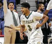  ?? Eric Gay / Associated Press ?? With Cypress Falls coach Richard Flores, left, leading the cheers, Trajan Wesley races to join Saturday’s celebratio­n of a Class 6A basketball title.