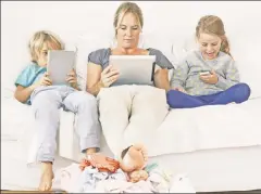  ??  ?? Disconnect­ed: Addictive social media increasing­ly atomize the family.