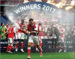  ??  ?? PARTY TIME: Alexis Sanchez (centre) leads the Arsenal celebratio­ns as champagne showers down on the men in red and white at Wembley