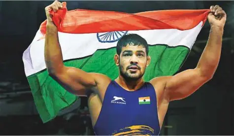  ?? PTI ?? India’s Sushil Kumar celebrates holding tricolour after winning a gold medal in the men’s freestyle 74kg wrestling final bout against South Africans’ Johannes Botha at the Commonweal­th Games 2018 in Gold Coast yesterday.