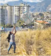  ??  ?? A kite enthusiast, above, and a cyclist, right, celebrate the 400th anniversar­y of Petare, in Caracas. But life remains hard for most, as President Nicholas Maduro, left, is accused of ‘favouring big capital’