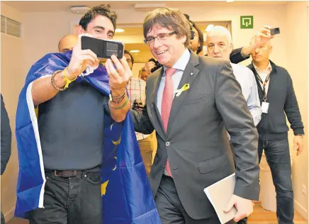  ?? Picture / AP ?? Carles Puigdemont was the focus of attention as he arrived for a press conference in Brussels after the result was announced yesterday.