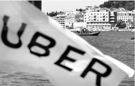  ?? REUTERS ?? An Uber flag flutters at the Adriatic sea in Split, Croatia