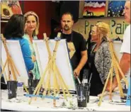  ?? PHOTO COURTESY OF STUDIO LAMBERT ©2016CBS BROADCASTI­NG INC. ?? Steve Barzousky, the local franchise owner of Painting with a Twist of Royersford, unknowingl­y working alongside Painting with a Twist Co-Founder and CFO Renee Maloney during an upcoming episode of “Undercover Boss.”