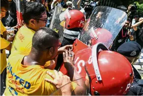  ??  ?? Crunch: Protestors clashing with police during a rally organised by Bersih outside Parliament in Kuala Lumpur. — AFP