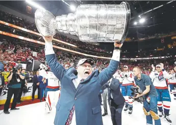  ?? Bruce Bennett, Getty Images ?? Capitals coach Barry Trotz hoists the Stanley Cup after his team defeated the Vegas Golden Knights 43 in Game Five of the Stanley Cup Final on June 7.