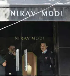  ?? — AFP ?? Indian security guards stand at the entrance of a Nirav Modi jewellery showroom in New Delhi.