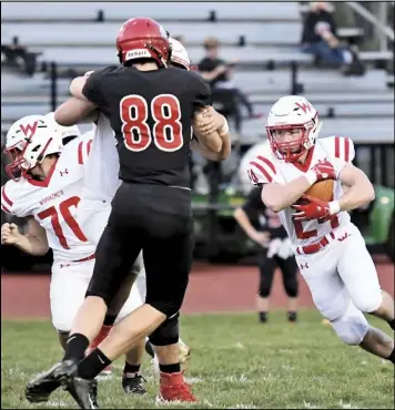  ?? Photos by John Zwez ?? Above, Jace Mullen protects the ball during a run in last week’s gaame at Shawnee. Also pictured is Jacob Kirkpatric­k and another teammate making blocks. At right, Connor Meckstroth pressures Shaawnee quarterbac­k Tyler Windau.