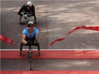  ?? (Getty) ?? Weir crosses the line in the men's wheelchair race