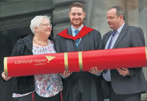  ??  ?? PROUD PARENTS: Fraser Chalmers with mother Sarah and father Ross at the graduation ceremony at the Usher Hall. Picture: Stewart Attwood