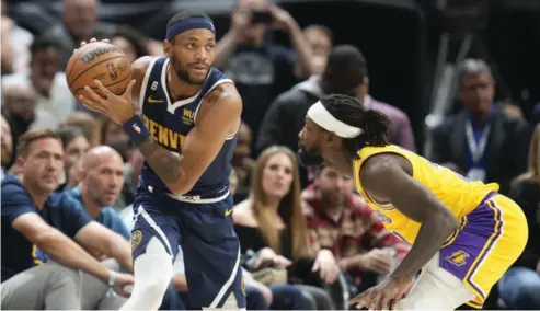  ?? AP/DAVID ZALUBOWSKI PHOTO ?? DENVER Nuggets forward Bruce Brown, left, looks to pass the ball as Los Angeles Lakers guard Patrick Beverley defends in the second half of an NBA basketball game Wednesday, Oct▪ 26, 2022, in Denver▪