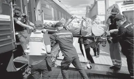  ?? FRANCISCO SECO/AP ?? A patient on a stretcher is loaded onto a medical evacuation train Sunday at the station in the eastern Ukrainian city of Pokrovsk.