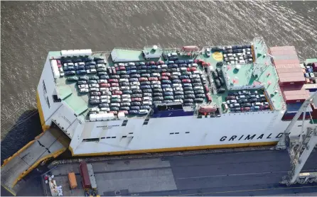  ?? — Reuters ?? Export cars are loaded on a Roro ship of Italian Grimaldi Group at a terminal in the port of Hamburg, Germany.