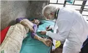  ?? — PTI ?? Prime Minister Narendra Modi gives an autograph to a woman who was injured after a portion of a tent collapsed at his rally, at a hospital in Midnapore, West Bengal, on Monday.