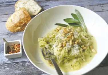  ?? SARA MOULTON/THE ASSOCIATED PRESS ?? Spaghetti squash topped with creamy goat cheese sauce and shredded zucchini is a simple but lovely meal.