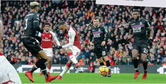  ??  ?? Coasting: Alexandre Lacazette makes it 4 4-0 0 to sink Crystal Palace