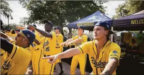  ?? Stephen B. Morton / Associated Press ?? Savannah Bananas pitcher Blake McGehee, right, dances during a pregame performanc­e for the fans waiting for the gates to open.