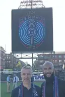  ?? THE COMMERCIAL APPEAL ?? Sporting director Andrew Bell and soccer legend Tim Howard pose for a photo at AutoZone Park, newly transforme­d into a soccer pitch, as they reveal the new Memphis 901 FC name and logo. KATHERINE BURGESS /