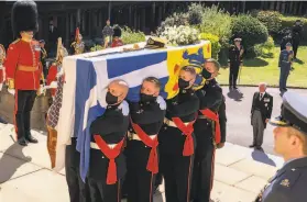  ?? Arthur Edwards / Getty Images ?? Pallbearer­s carry Prince Philip’s coffin to St. George’s Chapel on the grounds of Windsor Castle. Philip died April 9, two months shy of his 100th birthday.
