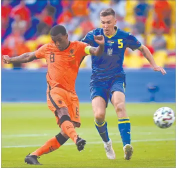  ?? Photo: Nampa/AFP ?? Holland jpg – On the move… Netherland­s’ midfielder Georginio Wijnaldum (L) attempts a shot as he is marked by Ukraine’s midfielder Serhiy Sydorchuk during the UEFA EURO 2020 Group C match at the Johan Cruyff Arena in Amsterdam on Sunday.