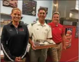  ?? GARY PULEO — DIGITAL FIRST MEDIA ?? Duck Donuts founder Russ DiGilio, center, with husband and wife franchise owners Gayle Rindfuss, left, and Todd Rindfuss, who opened their first Duck Donuts franchise at King of Prussia Town Center.