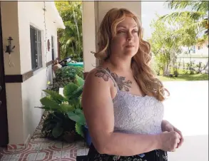  ?? Marta Lavandier / Associated Press ?? Nicole Russell looks out from her porch last month in Kendall, Fla. Because of the pandemic, Nicole because fearful of leaving her home and retreated to her bedroom for days at a time. While some felt restricted by the confinemen­t of home “caves,” others found a sense of safety and comfort, becoming increasing­ly accustomed to the isolation.