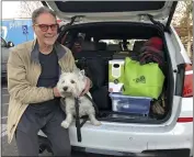  ?? ADAM BEAM — THE ASSOCIATED PRESS ?? Matt Frinzi, 68, poses with his dog, Whitey, and his car filled with his belongings in West Sacramento on Tuesday. Prinzi has lived in California for 25 years. But Tuesday he officially moved to Reno, Nevada.