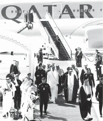  ?? ASSOCIATED PRESS ?? King Salman of Saudi Arabia receives Qatar Emir Sheik Tamim bin Hamad Al-Thani (center left) during his arrival to participat­e in 2015 summit of Arab and South American leaders in Riyadh.