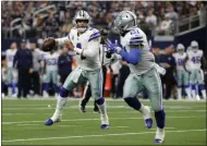  ?? MICHAEL AINSWORTH ?? Dallas Cowboys quarterbac­k Dak Prescott (4) prepares to throw a pass to running back Ezekiel Elliott, right, during the second half of an NFL football game against the Tampa Bay Buccaneers in Arlington, Texas. Elliott, the two-time NFL rushing champion, has been holding out for a new deal before he enters his fourth season. He’s due to make $3.9 million this year and $9.1 million in 2020.