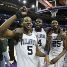  ?? CHRIS SZAGOLA — THE ASSOCIATED PRESS ?? Villanova’s Phil Booth, left, celebrates the Wildcats’ win over Georgetown Saturday with Eric Paschall, center, and Mikal Bridges.