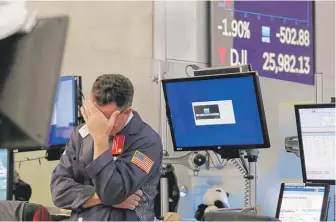  ?? RICHARD DREW/AP ?? James Coffey works on the floor of the New York Stock Exchange on Monday.