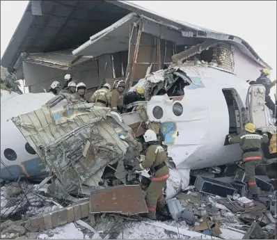  ?? PICTURE: AP PHOTO ?? AFTERMATH: Police and rescuers work on the side of the wreckage near Almaty Internatio­nal Airport, outside Almaty, Kazakhstan.