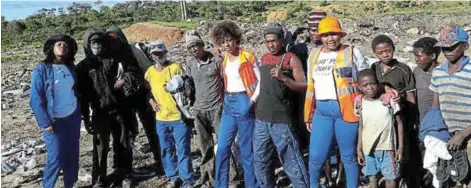  ??  ?? IGNITING HOPE: The non-profit organisati­on in Port Alfred, A Call for Change, led by founder Somila Sikhundla, left, and volunteers Jennita Gongota and Anesipho Nomatyenge (in orange vests) showed kindness to the people who scavenge at the dumpsite on Christmas day when they donated clothes