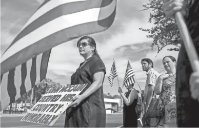  ??  ?? Melissa Arvizo holds a sign for John McCain on Central Avenue along Thursday’s motorcade route.