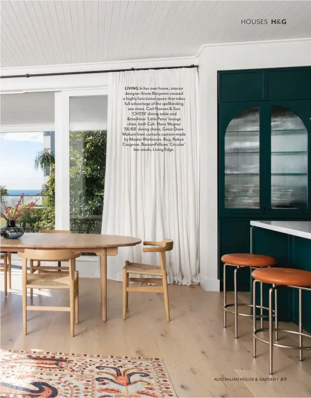  ??  ?? LIVING In her own home, interior designer Annie Benjamin created a highly functional space that takes full advantage of the spellbindi­ng sea views. Carl Hansen & Son ‘CH339’ dining table and &tradition ‘Little Petra’ lounge chair, both Cult. Hans Wegner ‘56/68’ dining chairs, Great Dane. Mokum linen curtains custom-made by Master Workroom. Rug, Robyn Cosgrove. BassamFell­ows ‘Circular’ bar stools, Living Edge.