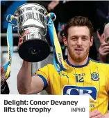  ??  ?? Delight: Conor Devaney lifts the trophy