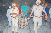  ??  ?? Police personnel taking the body of a victim who was run over by a speeding train in Amritsar on October 19, 2018. HT FILE