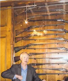  ??  ?? Displaying a window box of old Western rifles, Strater Hotel owner Rod Barker says the hotel is a living history museum.