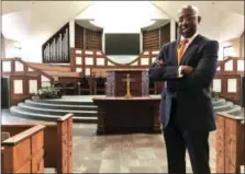  ?? JEFF MARTIN — THE ASSOCIATED PRESS ?? The Rev. Raphael Warnock stands Jan. 11in the sanctuary of Ebenezer Baptist Church in Atlanta. Warnock is senior pastor of the congregati­on once led by the Rev. Martin Luther King Jr.