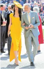  ?? AFP ?? Hollywood actor George Clooney, wearing a grey suit, walked arm in arm with his campaignin­g lawyer wife Amal, who wore a yellow dress and matching hat. —