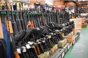  ?? AP FILE ?? Semi-automatic rifles are displayed at a shop in Auburn, Maine. The House passed legislatio­n in July to revive a 1990s-era ban on certain semi-automatic guns.