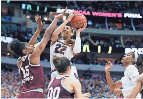  ?? TONY GUTIERREZ/AP ?? South Carolina forward A’ja Wilson shoots over Mississipp­i State center Teaira McCowan, left, during the women’s NCAA championsh­ip game Sunday in Dallas. Wilson scored 23 points to lead the Gamecocks.
