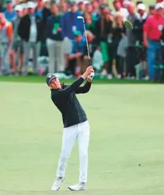  ?? AFP ?? Jordan Spieth plays his third shot on the 18th hole during the final round at Augusta National Golf Club on Sunday.