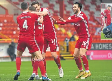  ??  ?? Sub Callum Hendry is mobbed by his team-mates after scoring with his first touch