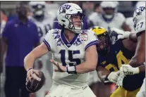  ?? RICK SCUTERI — THE ASSOCIATED PRESS ?? TCU quarterbac­k Max Duggan (15) looks to pass against Michigan during the first half of the Fiesta Bowl college football semifinal playoff game.